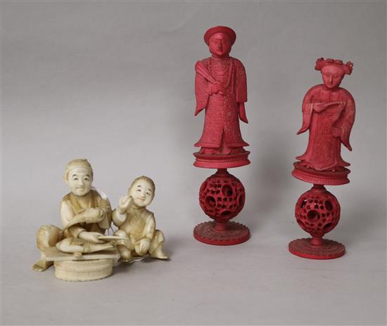 Two carved stained ivory chess pieces and ivory figurative group